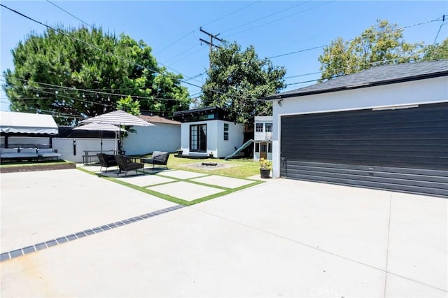 5855 Daneland St, Lakewood, CA 90713 - view of front facade with an outbuilding, a garage, and a patio