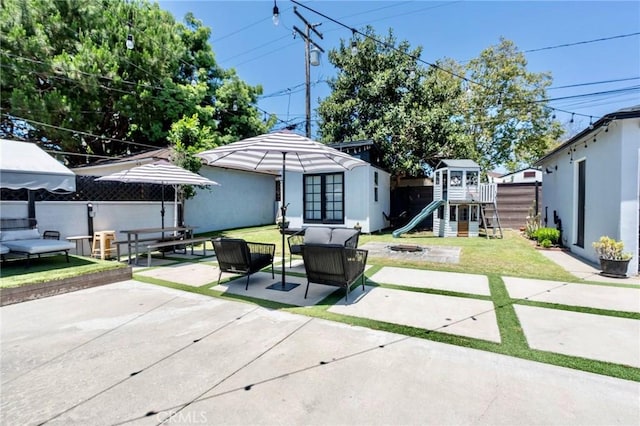 5855 Daneland St, Lakewood, CA 90713 - view of patio featuring a playground, an outdoor living space with a fire pit, and french doors