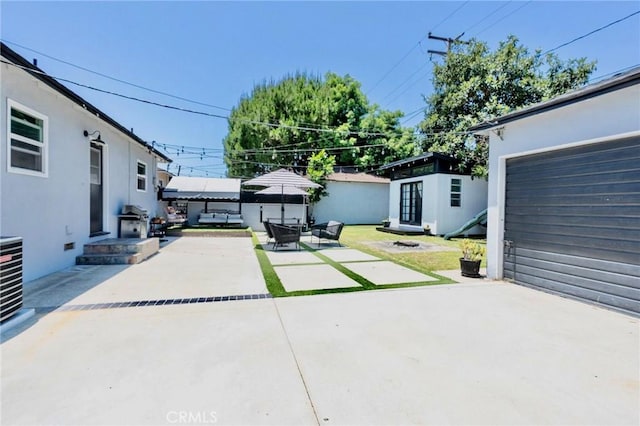 5855 Daneland St, Lakewood, CA 90713 - view of patio / terrace featuring an outbuilding, concrete driveway, and outdoor lounge area