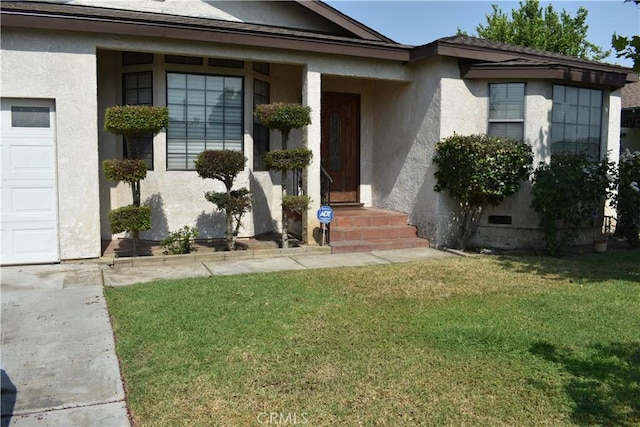 1331 Bothwell Ave, Colton, CA 92324 - doorway to property with stucco siding, a lawn, and an attached garage
