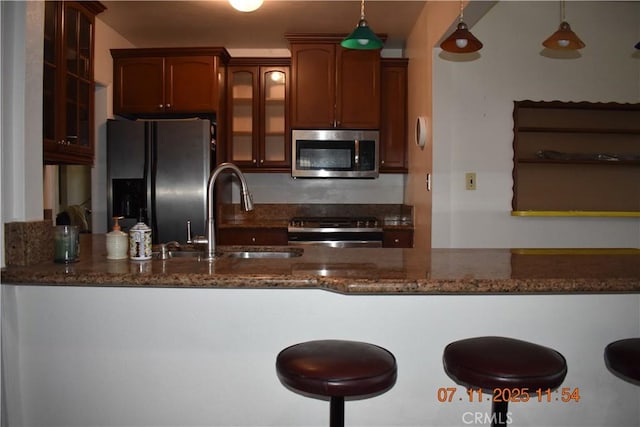 1331 Bothwell Ave, Colton, CA 92324 - kitchen featuring appliances with stainless steel finishes, dark stone countertops, and glass insert cabinets
