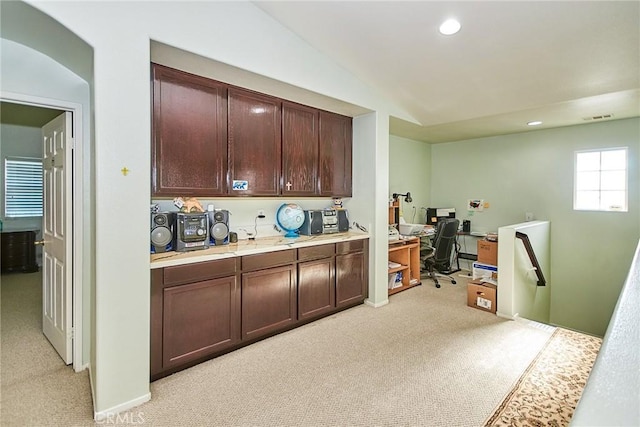 12672 Bellflower Ln, Moreno Valley, CA 92555 - kitchen with light carpet, a desk, light countertops, recessed lighting, and dark brown cabinets