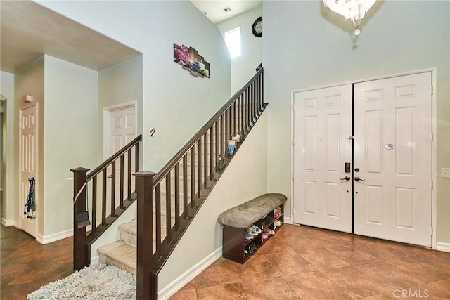 12672 Bellflower Ln, Moreno Valley, CA 92555 - entryway with tile patterned floors, stairway, and a towering ceiling