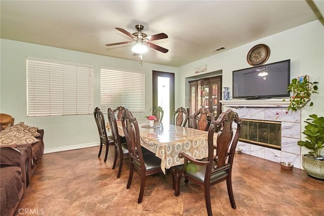 12672 Bellflower Ln, Moreno Valley, CA 92555 - dining room with ceiling fan, tile patterned flooring, and a fireplace