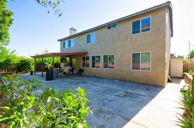 12672 Bellflower Ln, Moreno Valley, CA 92555 - rear view of property featuring stucco siding, a patio area, and a chimney