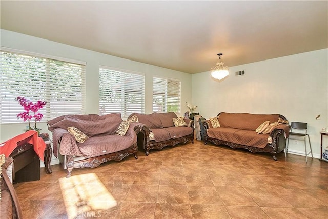 12672 Bellflower Ln, Moreno Valley, CA 92555 - living room featuring plenty of natural light and a chandelier