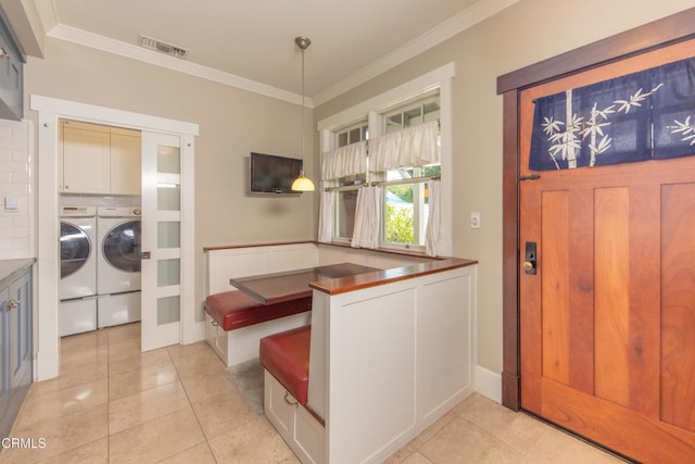 5512 Ranchito Ave, Sherman Oaks, CA 91401 - entrance foyer featuring independent washer and dryer, crown molding, and light tile patterned flooring