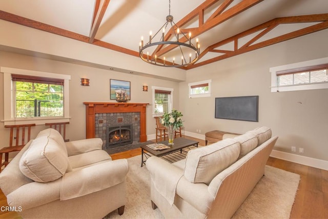 5512 Ranchito Ave, Sherman Oaks, CA 91401 - living room with wood finished floors, healthy amount of natural light, a tiled fireplace, beamed ceiling, and high vaulted ceiling