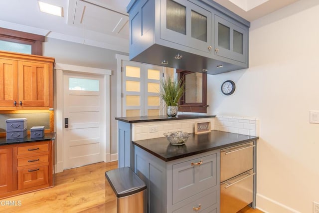 5512 Ranchito Ave, Sherman Oaks, CA 91401 - kitchen featuring light wood-style flooring, glass insert cabinets, and brown cabinets