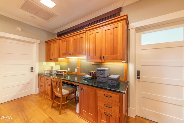 5512 Ranchito Ave, Sherman Oaks, CA 91401 - kitchen with built in desk, brown cabinets, light wood finished floors, and dark stone countertops