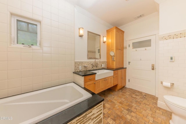 5512 Ranchito Ave, Sherman Oaks, CA 91401 - full bathroom featuring crown molding, a bath, vanity, tile walls, and tasteful backsplash