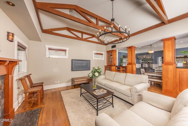 5512 Ranchito Ave, Sherman Oaks, CA 91401 - living room featuring ornate columns, a chandelier, wood finished floors, a fireplace, and recessed lighting