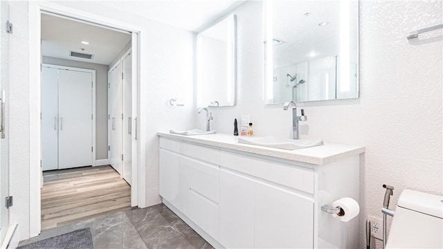 3131 Michelson Dr Unit 901, Irvine, CA 92612 - bathroom featuring double vanity, marble finish flooring, recessed lighting, and a shower