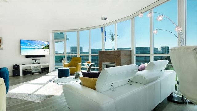 3131 Michelson Dr Unit 901, Irvine, CA 92612 - living area with wood finished floors, a wall of windows, a city view, and a fireplace
