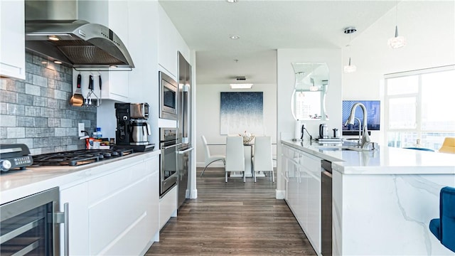 3131 Michelson Dr Unit 901, Irvine, CA 92612 - kitchen featuring exhaust hood, wine cooler, modern cabinets, and stainless steel appliances