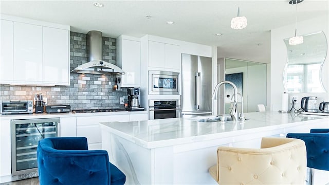 3131 Michelson Dr Unit 901, Irvine, CA 92612 - kitchen with appliances with stainless steel finishes, beverage cooler, wall chimney range hood, modern cabinets, and tasteful backsplash