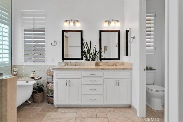 10844 Aster Ln, Apple Valley, CA 92308 - full bathroom featuring double vanity, a soaking tub, and stone tile flooring