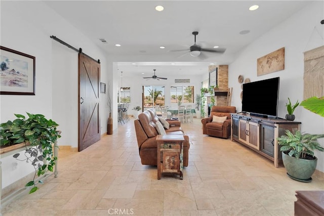 10844 Aster Ln, Apple Valley, CA 92308 - living room with a barn door, stone tile flooring, recessed lighting, and ceiling fan