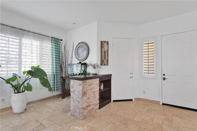 10844 Aster Ln, Apple Valley, CA 92308 - foyer with baseboards and stone tile floors