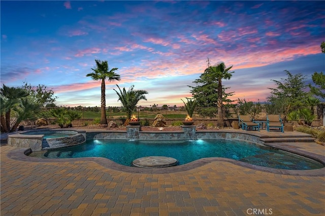 10844 Aster Ln, Apple Valley, CA 92308 - pool at dusk featuring a patio, a pool with connected hot tub, and a fenced backyard