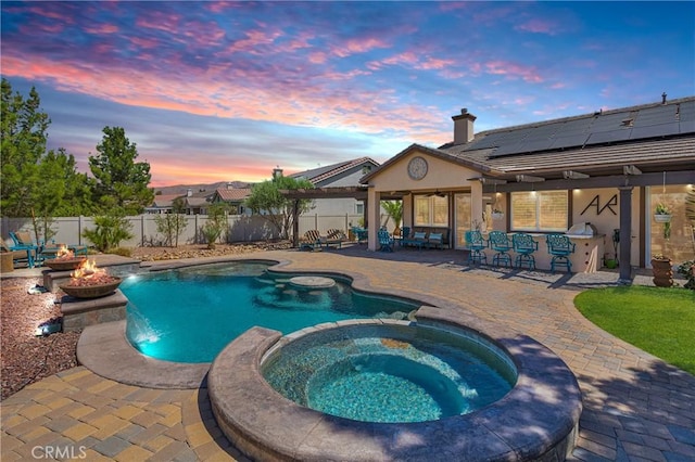 10844 Aster Ln, Apple Valley, CA 92308 - view of pool featuring a fire pit, a pool with connected hot tub, a fenced backyard, and a patio