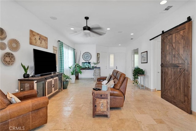 10844 Aster Ln, Apple Valley, CA 92308 - living area with a barn door, plenty of natural light, ceiling fan, stone tile floors, and recessed lighting