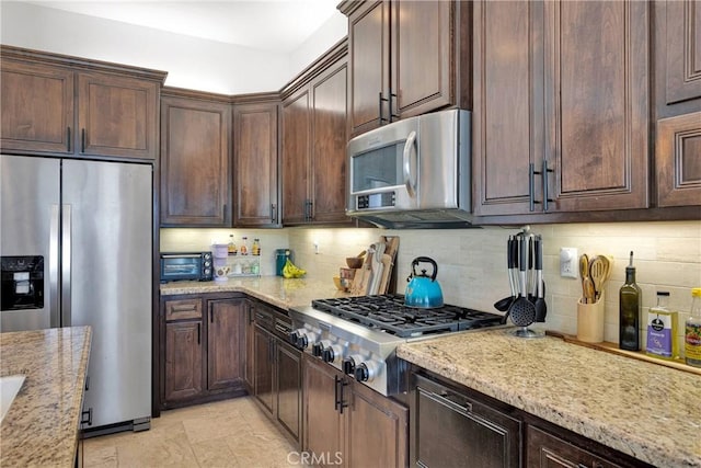 10844 Aster Ln, Apple Valley, CA 92308 - kitchen with stainless steel appliances, decorative backsplash, light stone counters, and dark brown cabinets