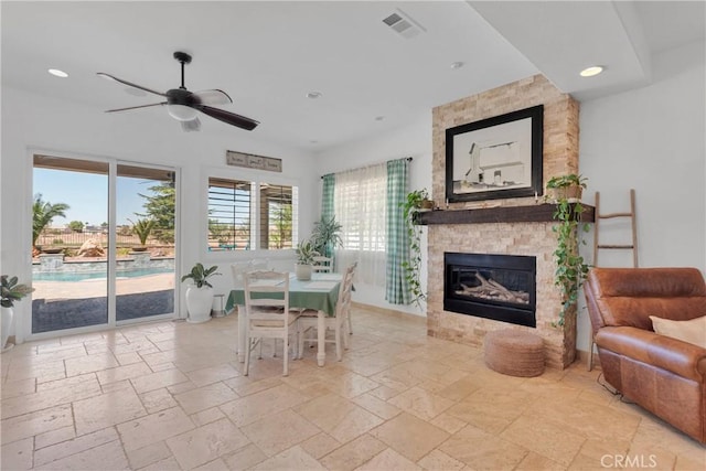 10844 Aster Ln, Apple Valley, CA 92308 - dining space featuring ceiling fan, stone tile flooring, a fireplace, and recessed lighting
