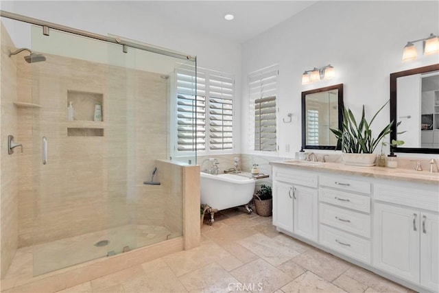 10844 Aster Ln, Apple Valley, CA 92308 - full bathroom featuring a shower stall, double vanity, a soaking tub, stone tile floors, and recessed lighting