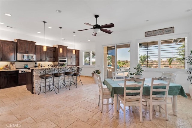 10844 Aster Ln, Apple Valley, CA 92308 - dining area featuring ceiling fan, stone tile flooring, and recessed lighting