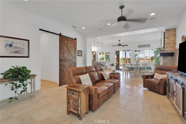 10844 Aster Ln, Apple Valley, CA 92308 - living area featuring a barn door, a ceiling fan, stone tile flooring, and recessed lighting