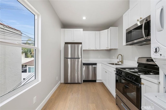 1221 E 1st St, Long Beach, CA 90802 - kitchen featuring appliances with stainless steel finishes, light wood-style floors, white cabinetry, light countertops, and recessed lighting