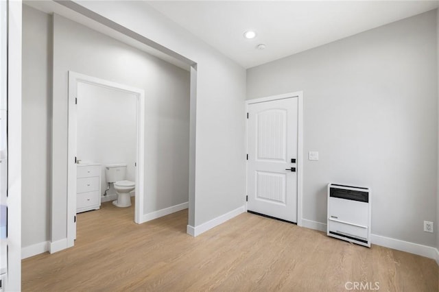 1221 E 1st St, Long Beach, CA 90802 - unfurnished bedroom featuring light wood finished floors, heating unit, recessed lighting, and ensuite bath