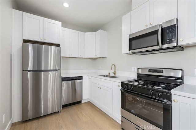 1221 E 1st St, Long Beach, CA 90802 - kitchen with stainless steel appliances, light wood finished floors, light countertops, white cabinetry, and recessed lighting