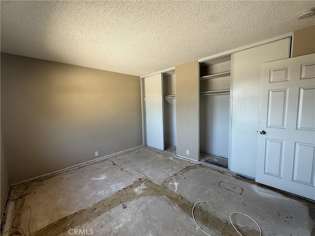 2854 Coronado Ave, San Diego, CA 92154 - unfurnished bedroom featuring multiple closets and a textured ceiling