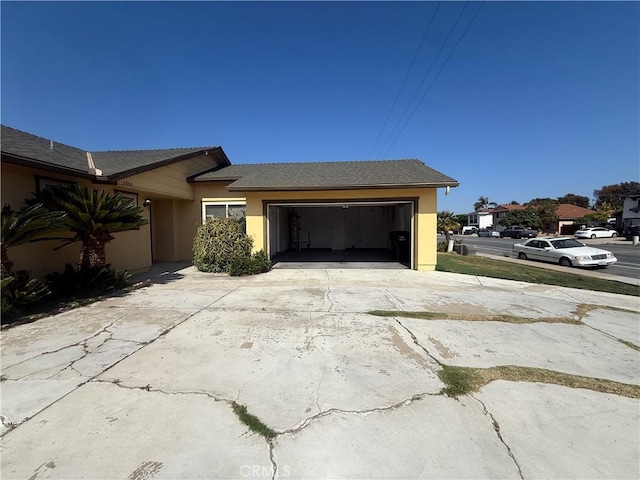2854 Coronado Ave, San Diego, CA 92154 - view of side of home with driveway, an attached garage, and stucco siding