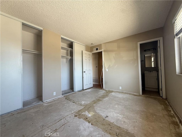 2854 Coronado Ave, San Diego, CA 92154 - unfurnished bedroom featuring two closets and a textured ceiling
