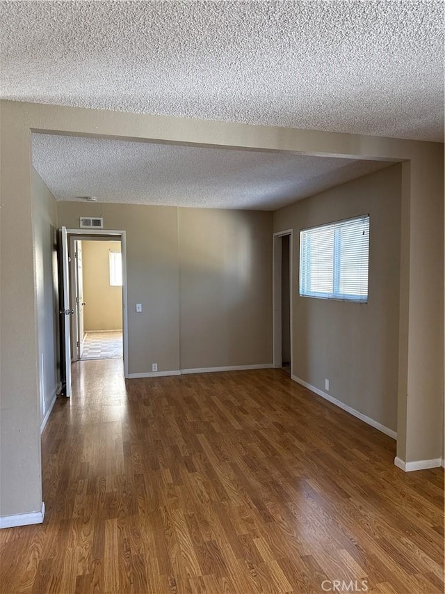 2854 Coronado Ave, San Diego, CA 92154 - unfurnished room featuring a textured ceiling and wood finished floors