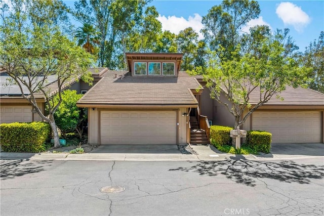 1828 Wintergreen, Escondido, CA 92026 - mid-century modern home featuring a garage, a tile roof, and driveway