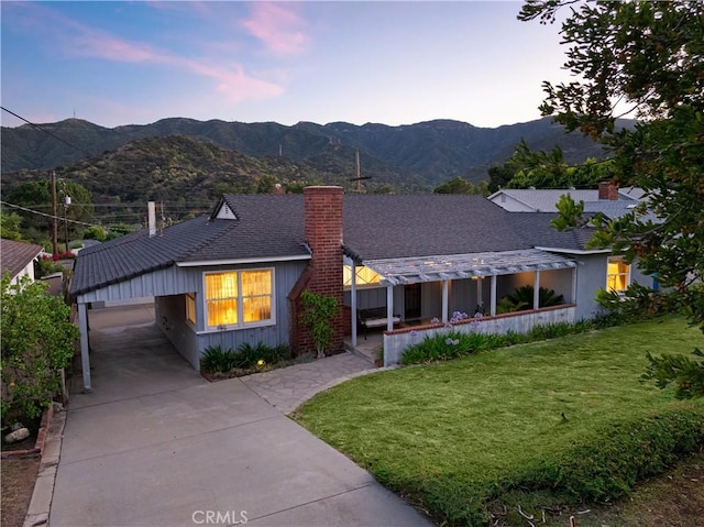 2900 Manhattan Ave, La Crescenta, CA 91214 - ranch-style home with a chimney, a mountain view, a front yard, driveway, and board and batten siding