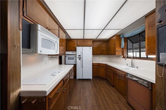 2900 Manhattan Ave, La Crescenta, CA 91214 - kitchen featuring white appliances, dark wood-style floors, light countertops, and brown cabinets