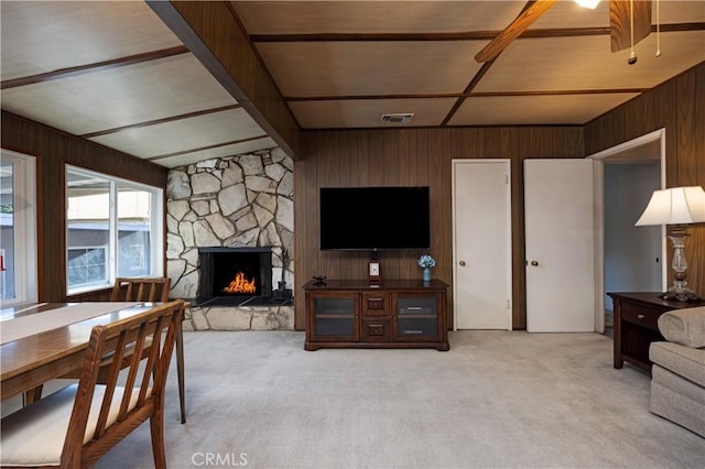 2900 Manhattan Ave, La Crescenta, CA 91214 - living room featuring light colored carpet, wooden walls, a stone fireplace, and beamed ceiling
