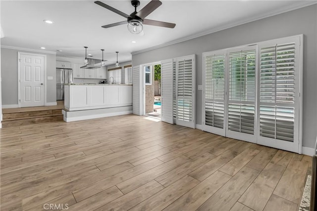 3652 San Joaquin Ave, Los Alamitos, CA 90720 - unfurnished living room with crown molding, ceiling fan, light wood-type flooring, and recessed lighting