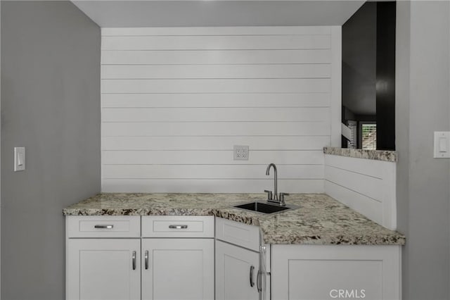 3652 San Joaquin Ave, Los Alamitos, CA 90720 - kitchen featuring white cabinetry and light stone counters