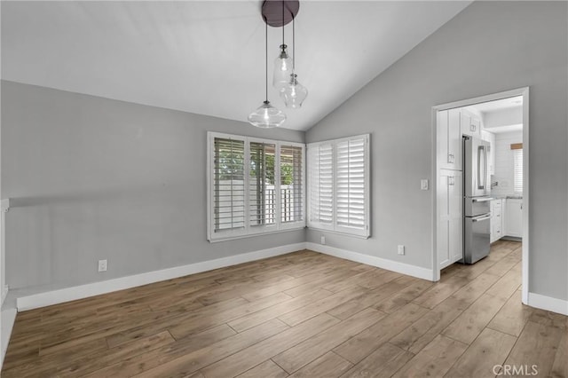 3652 San Joaquin Ave, Los Alamitos, CA 90720 - unfurnished dining area with wood finished floors and lofted ceiling