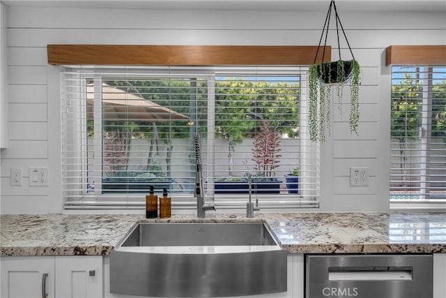 3652 San Joaquin Ave, Los Alamitos, CA 90720 - kitchen with light stone counters, white cabinets, and stainless steel dishwasher