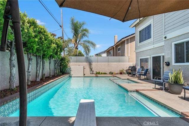 3652 San Joaquin Ave, Los Alamitos, CA 90720 - view of swimming pool featuring a fenced backyard, a diving board, a patio area, and a pool with connected hot tub