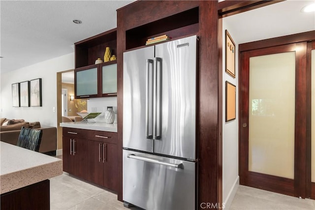 26356 Sorrell Pl, Laguna Hills, CA 92653 - kitchen with high end fridge, dark brown cabinets, light tile patterned flooring, open floor plan, and open shelves