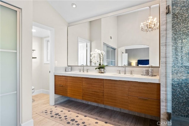26356 Sorrell Pl, Laguna Hills, CA 92653 - bathroom featuring double vanity, a chandelier, recessed lighting, and wood finished floors