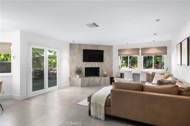 26356 Sorrell Pl, Laguna Hills, CA 92653 - living room with plenty of natural light, light tile patterned floors, a premium fireplace, and recessed lighting